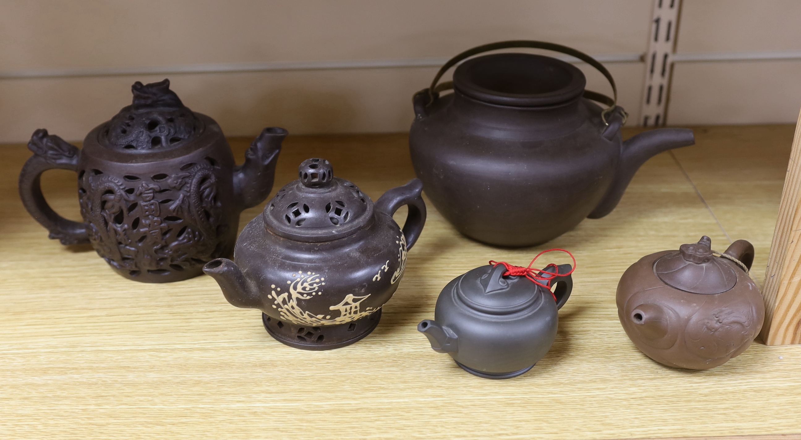 A quantity of Chinese Yixing teapots and terracotta tea bowls, the largest 20cm wide